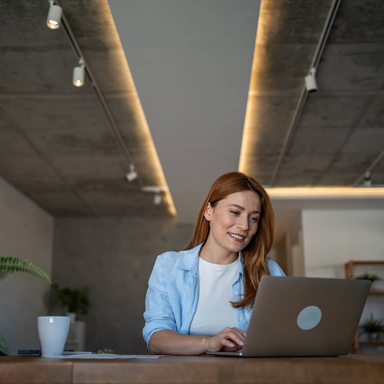 Smiling woman behind laptop