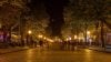 City street at night with a warm, golden glow