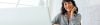 Smiling woman behind laptop